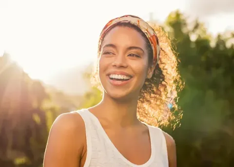 smiling girl with curly hair and headband