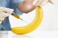 Peyronie's disease and treatments represented with a banana and syringe