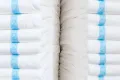 two stacks of white adult diapers