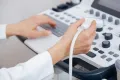 a technician works on an ultrasound machine