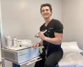 Shockwave therapy machine in the hands of Co-author Tony Allemon PA-C