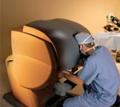 a technician looks into a device used for robotic surgery