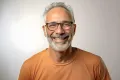 Smiling middle-aged man wearing glasses, representing life improvement after the Rezum Procedure for BPH.