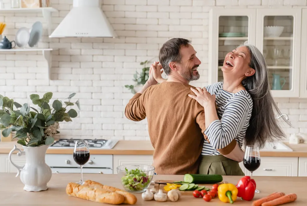happy couple in kitchen dancing